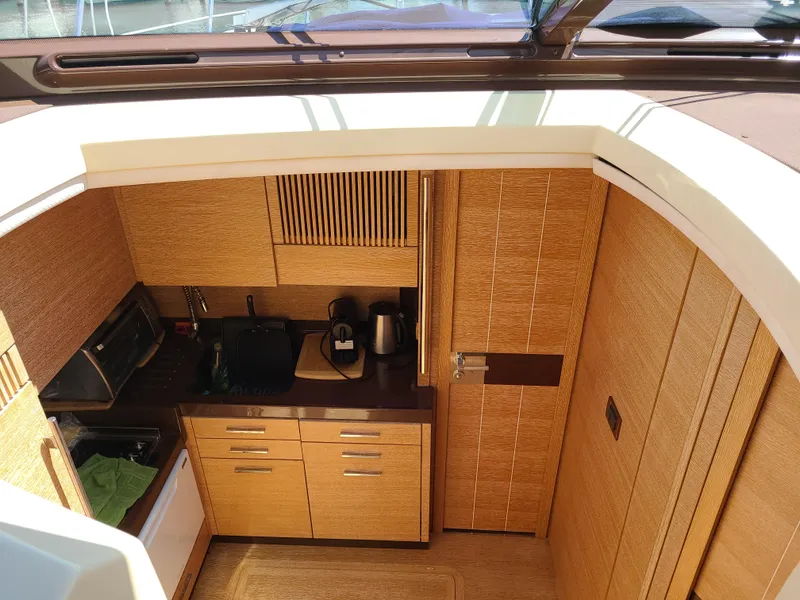 Slide: The Image of Modern kitchen area in a 2011 Azimut 47 yacht with wooden cabinetry. - 38