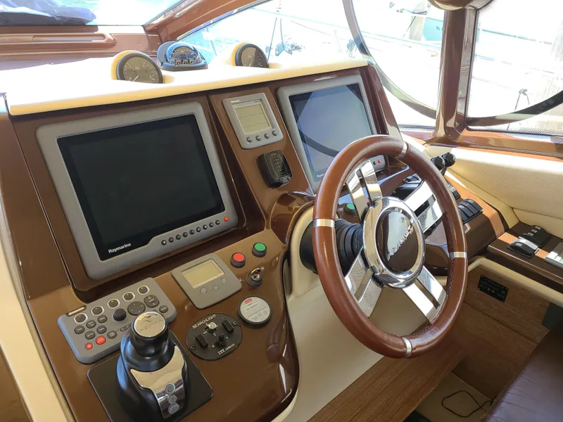 Slide: The Image of Control panel of a 2011 Azimut 47 yacht with steering wheel and navigation screens. - 14