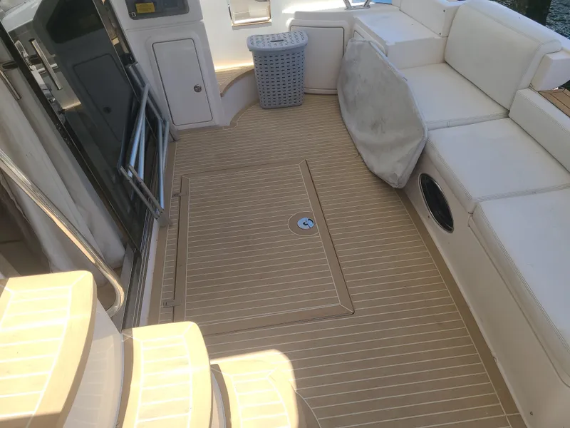 Slide: The Image of Azimut 47 2011 yacht deck with beige flooring and white seating. - 8