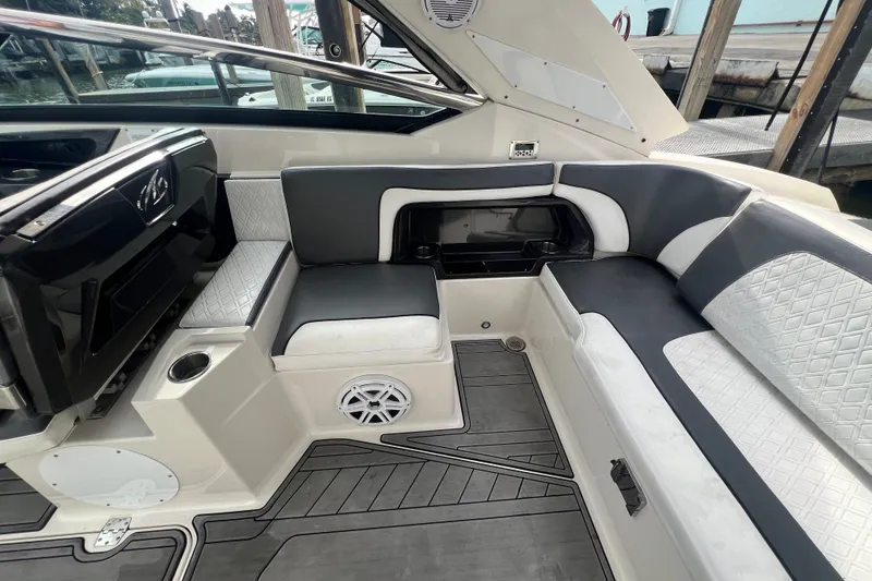 Slide: The Image of Interior of a 2011 Monterey 328SS Super Sport boat with cushioned seating. - 27