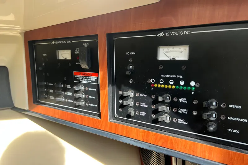 Slide: The Image of Control panel of a 2011 Monterey 328SS Super Sport boat, featuring AC and DC systems. - 38