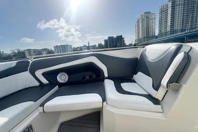 Slide: The Image of 2011 Monterey 328SS Super Sport boat interior with modern seating and cityscape background. - 15