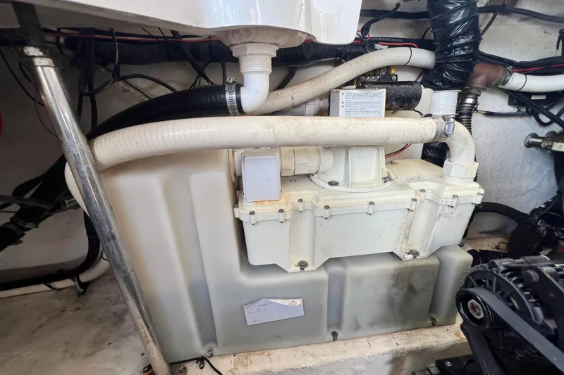 Slide: The Image of Engine compartment of a 2011 Monterey 328SS Super Sport boat, featuring hoses and mechanical components. - 44