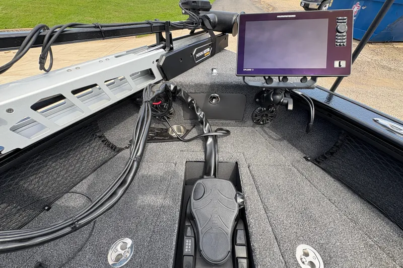 Slide: The Image of 2025 Lund 1875 Pro-V boat interior with advanced navigation system and foot pedal controls. - 11