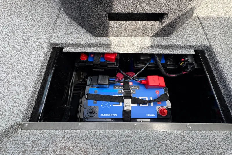 Slide: The Image of 2025 Lund 1875 Pro-V boat battery compartment with secured deep cycle battery. - 27