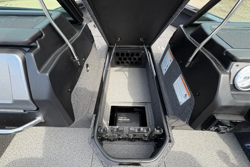 Slide: The Image of Interior view of 2025 Lund 1875 Pro-V boat, showcasing storage compartment and dashboard details. - 19