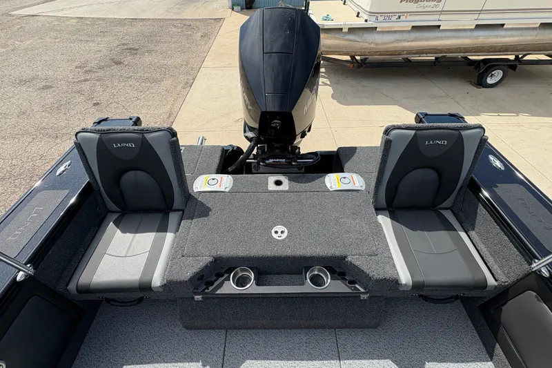 Slide: The Image of 2025 Lund 1875 Pro-V boat interior with seating and motor, showcasing modern design and functionality. - 38