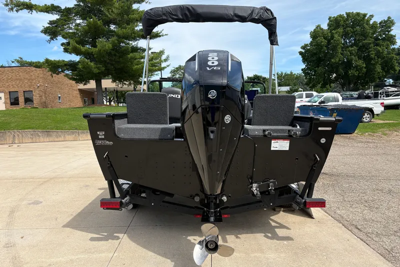 Slide: The Image of 2025 Lund 1875 Pro-V boat with powerful 300 V6 engine, parked outdoors. - 3