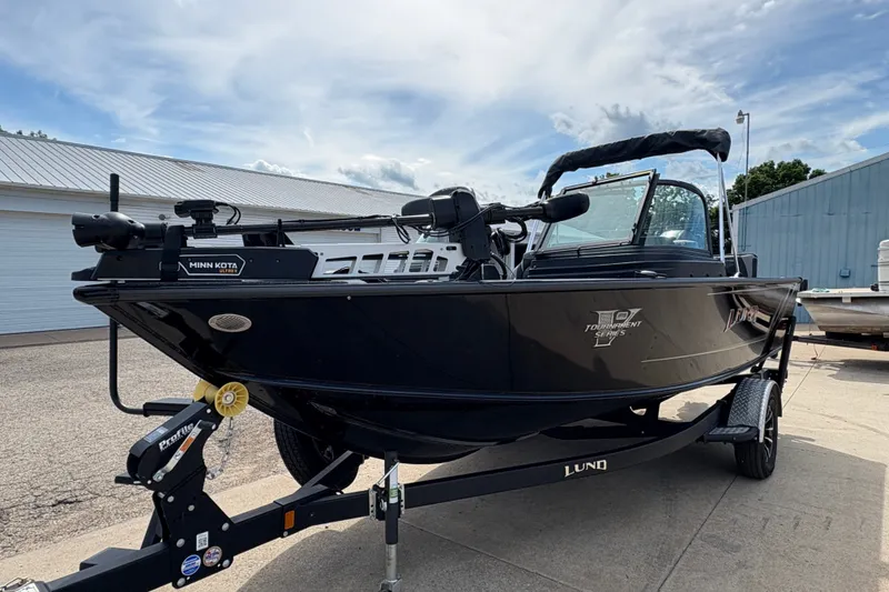 Slide: The Image of 2025 Lund 1875 Pro-V fishing boat on trailer, featuring Minn Kota trolling motor. - 5