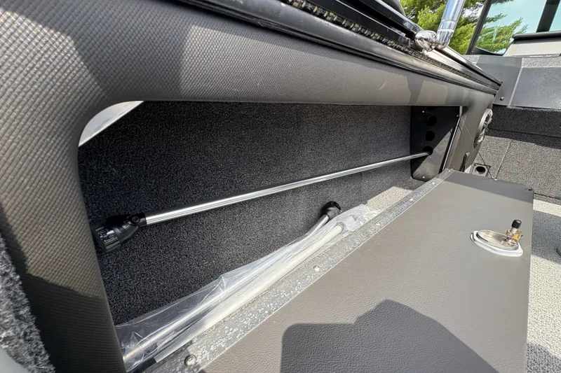 Slide: The Image of Interior storage compartment of 2025 Lund 1875 Pro-V boat, showcasing sleek design and functionality. - 36