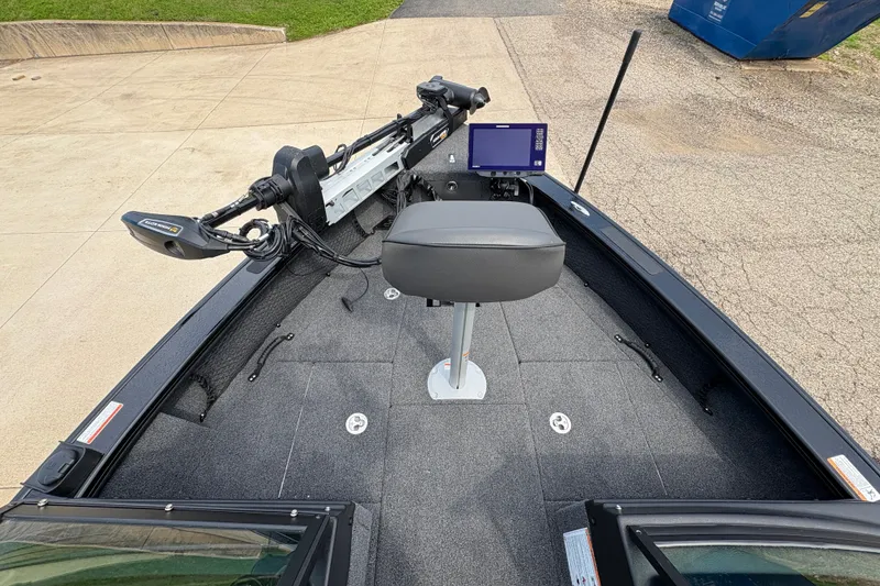Slide: The Image of 2025 Lund 1875 Pro-V boat interior with seat, control panel, and trolling motor. - 10