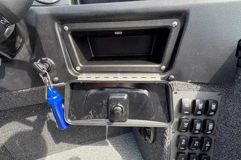 Slide: The Image of Dashboard of 2025 Lund 1875 Pro-V boat with ignition key and control switches. - 23