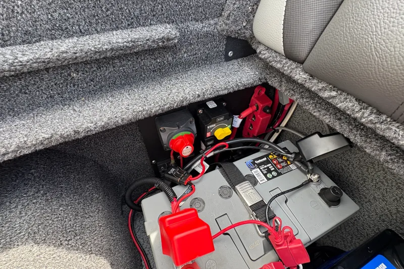 Slide: The Image of Battery compartment of 2025 Lund 1875 Pro-V boat, featuring wiring and connections. - 42