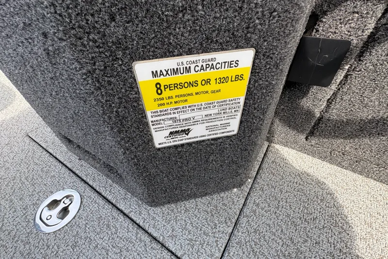 Slide: The Image of 2025 Lund 1875 Pro-V boat capacity label, 8 persons or 1320 lbs, U.S. Coast Guard compliant. - 26