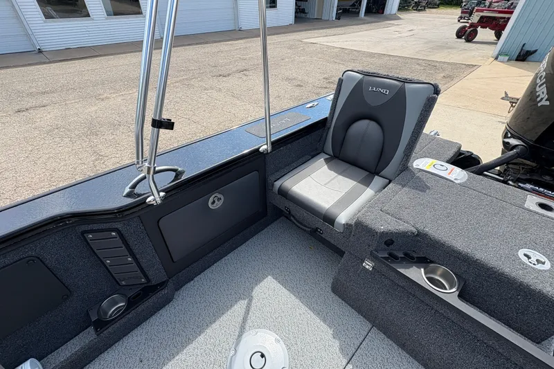 Slide: The Image of 2025 Lund 1875 Pro-V boat interior with gray seating and storage compartments. - 32