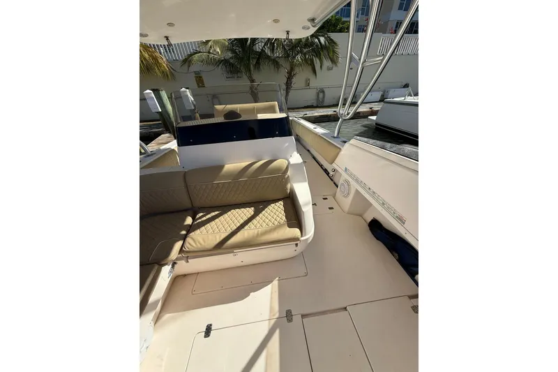 Slide: The Image of 2008 Intrepid 370 Cuddy boat interior with beige seating and open deck. - 35