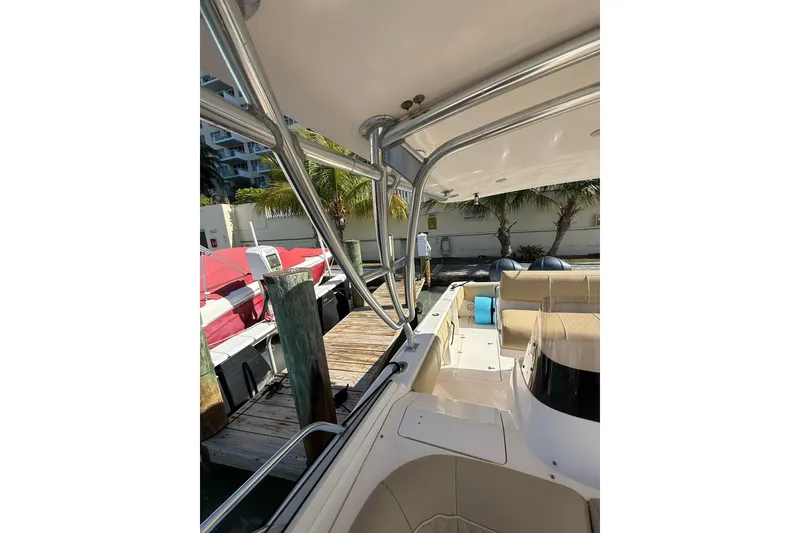 Slide: The Image of 2008 Intrepid 370 Cuddy boat interior with seating and dock view. - 37