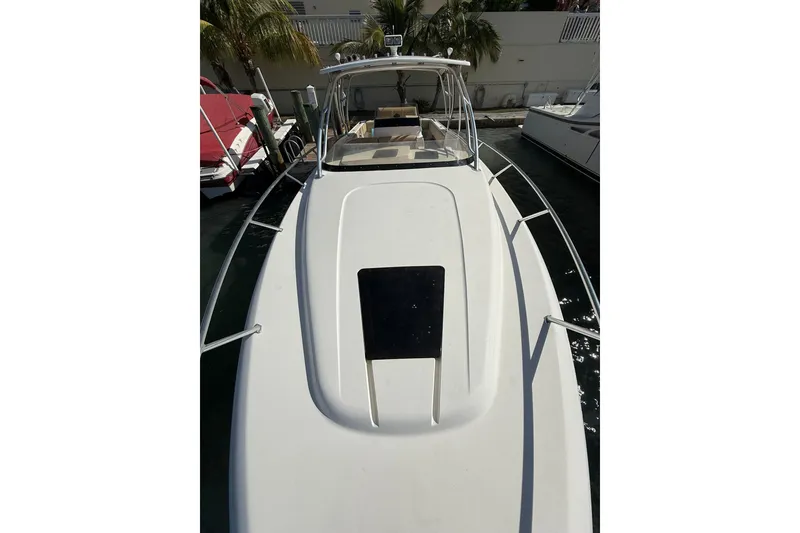 Slide: The Image of 2008 Intrepid 370 Cuddy boat docked, showcasing sleek design and spacious deck. - 40