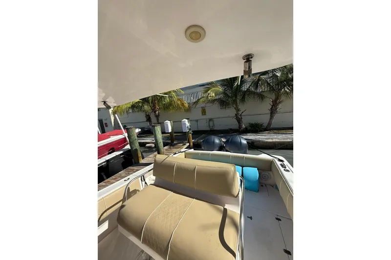 Slide: The Image of 2008 Intrepid 370 Cuddy boat interior with seating and dock view. - 22