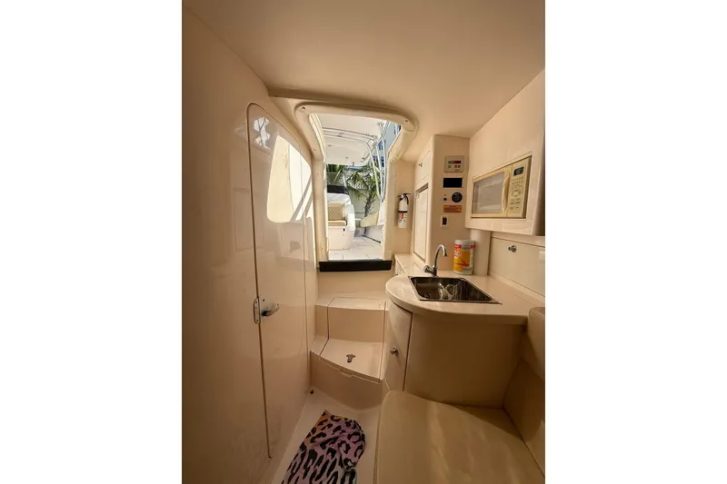 Slide: The Image of Interior of 2008 Intrepid 370 Cuddy boat featuring kitchenette and seating area. - 54