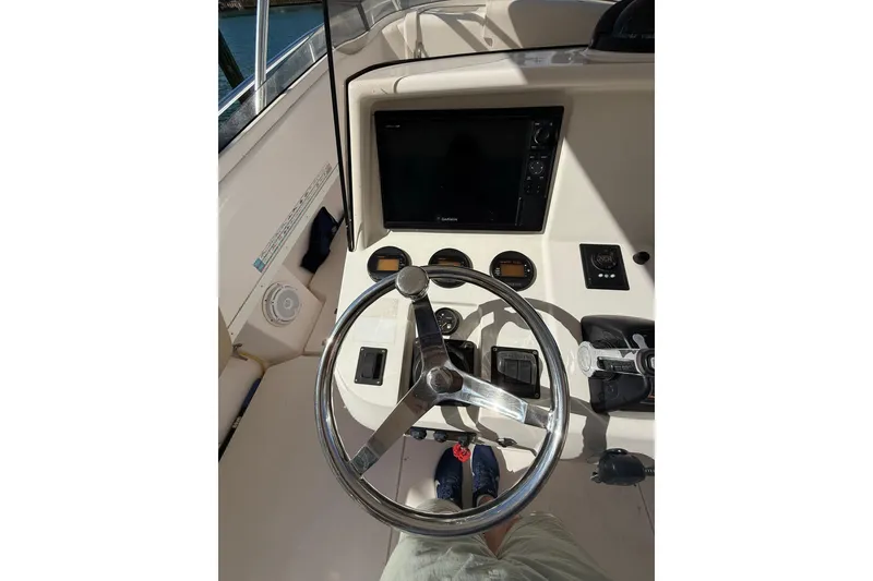 Slide: The Image of 2008 Intrepid 370 Cuddy helm with steering wheel and navigation controls. - 18