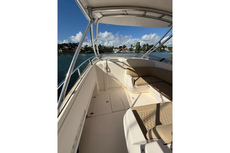 Slide: The Image of 2008 Intrepid 370 Cuddy boat interior with cushioned seating and waterfront view. - 28