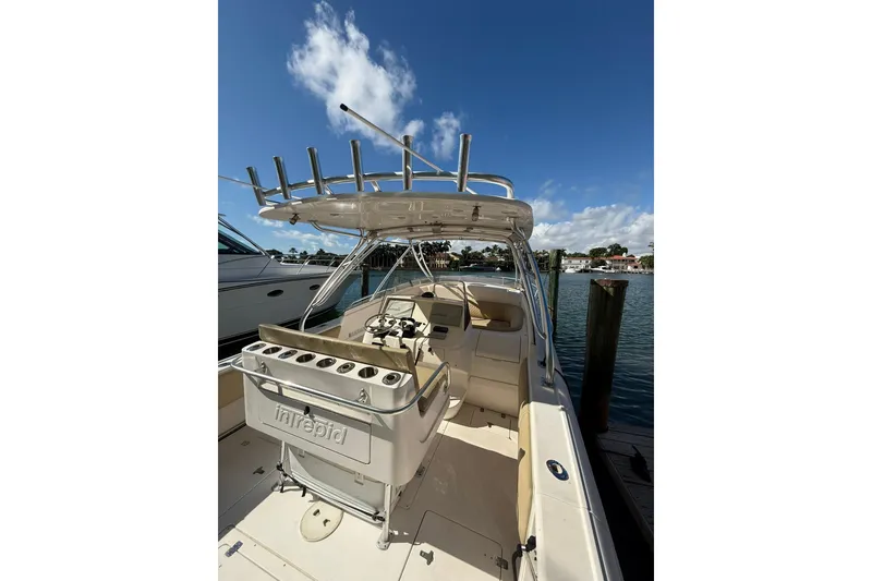 Slide: The Image of 2008 Intrepid 370 Cuddy boat docked under clear blue sky. - 10