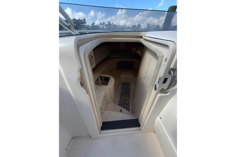Slide: The Image of 2008 Intrepid 370 Cuddy cabin interior with open door, showcasing seating and compact design. - 46