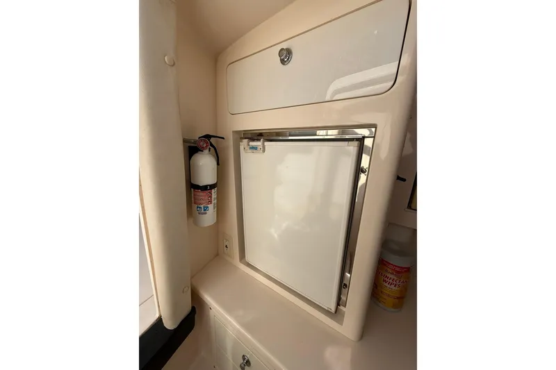 Slide: The Image of 2008 Intrepid 370 Cuddy interior with fire extinguisher and storage compartment. - 59