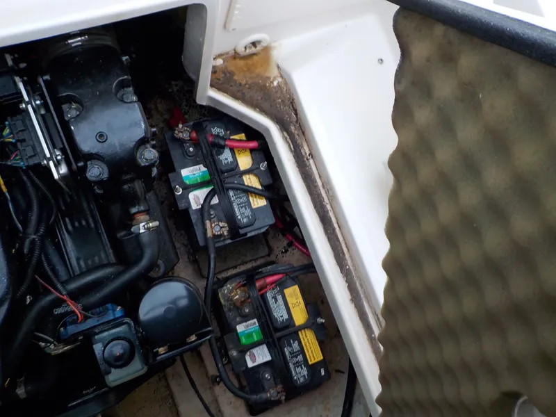Slide: The Image of The engine compartment of a 2004 Sea Ray 225 Weekender with batteries and engine components. - 21