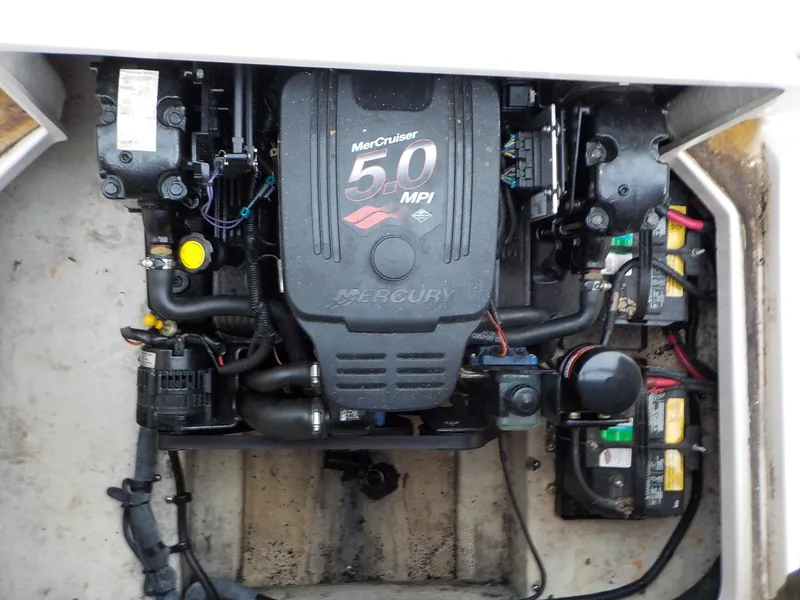Slide: The Image of The engine compartment of a 2004 Sea Ray 225 Weekender features a MerCruiser 5.0 MPI engine. - 19