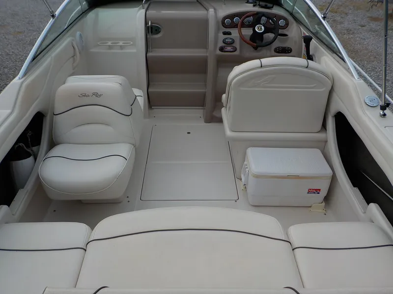 Slide: The Image of The image shows the cockpit of a 2004 Sea Ray 225 Weekender with beige seating. - 16