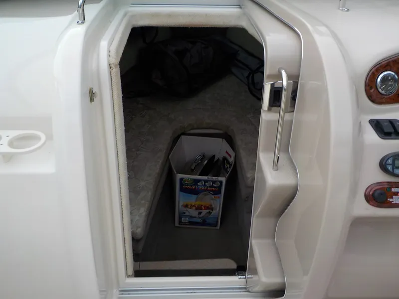 Slide: The Image of The cabin of a 2004 Sea Ray 225 Weekender with a small entrance and starboard instruments. - 18
