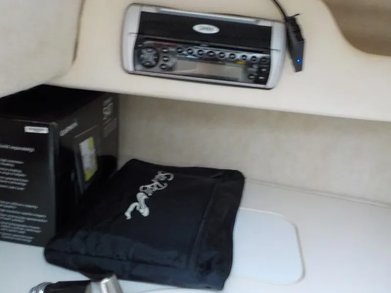 Slide: The Image of Interior of a 2004 Sea Ray 225 Weekender with stereo system and accessories. - 20