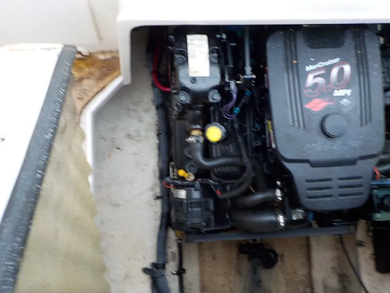 Slide: The Image of A 2004 Sea Ray 225 Weekender with a MerCruiser 5.0 MPI engine in the engine compartment. - 23