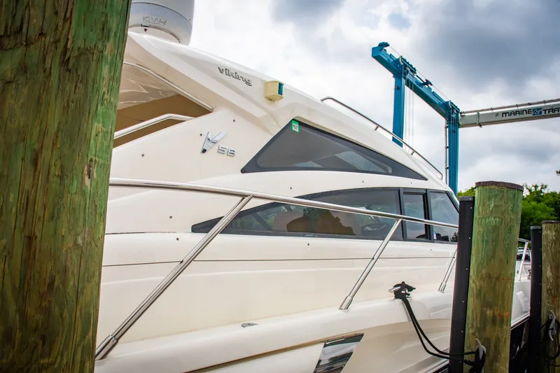 Slide: The Image of 2008 Princess V58 yacht docked at marina, side view with overcast sky. - 16