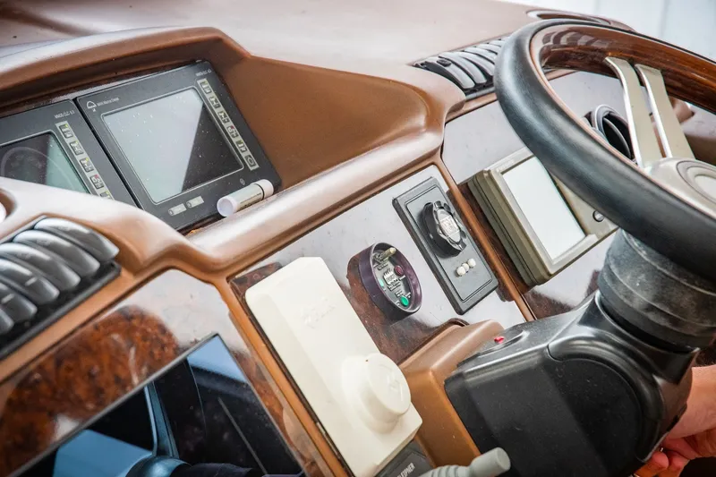 Slide: The Image of Control panel of a 2008 Princess V58 yacht with steering wheel and navigation displays. - 6