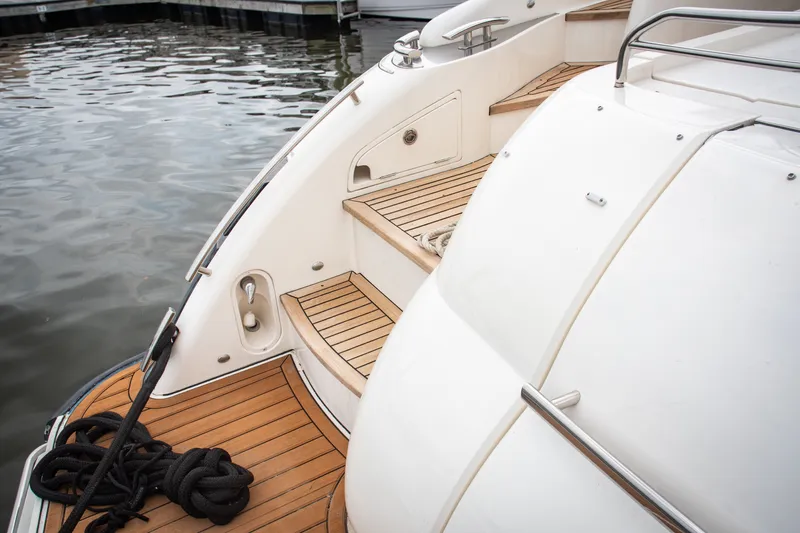 Slide: The Image of Luxury yacht Princess V58, 2008 model, featuring elegant teak decking and sleek design. - 11