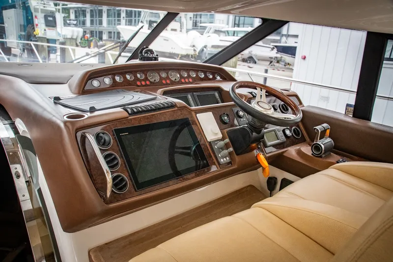 Slide: The Image of Helm of 2008 Princess V58 yacht with modern navigation controls and leather seating. - 5
