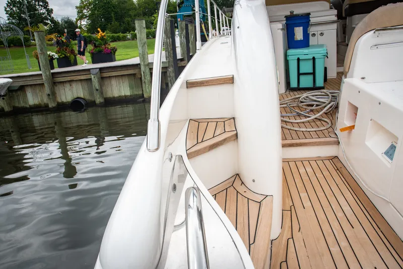 Slide: The Image of 2008 Princess V58 yacht with teak deck, docked near a garden. - 12