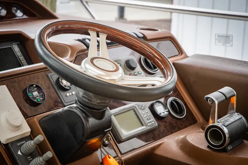 Slide: The Image of Steering wheel and controls of a 2008 Princess V58 yacht cockpit. - 8