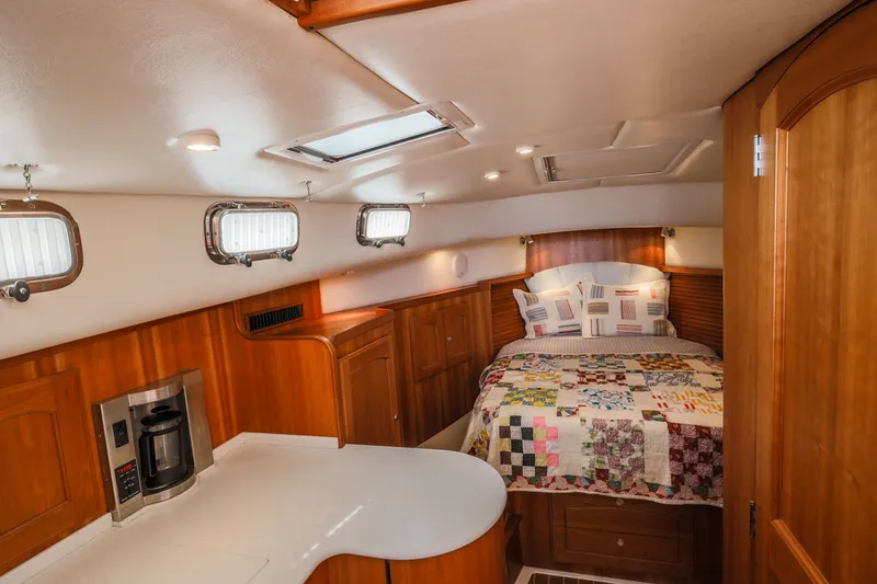 Slide: The Image of Luxurious 2007 Legacy 32 Express cabin interior with cozy bed and kitchenette. - 1