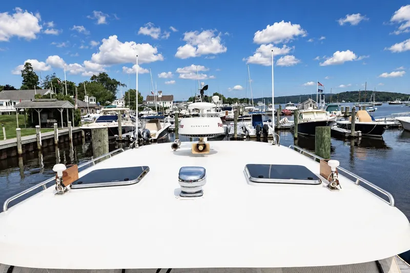 Slide: The Image of 2007 Legacy 32 Express yacht docked at a marina under a clear blue sky. - 15