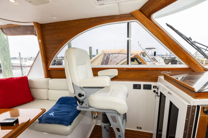 Slide: The Image of Interior of 2007 Legacy 32 Express yacht with white seating and wooden accents. - 4