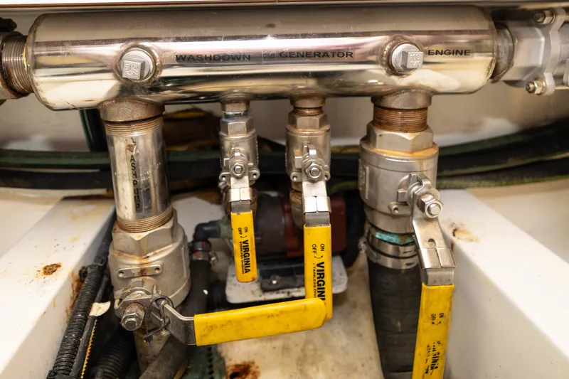 Slide: The Image of Engine compartment valves of a 2007 Legacy 32 Express boat. - 17