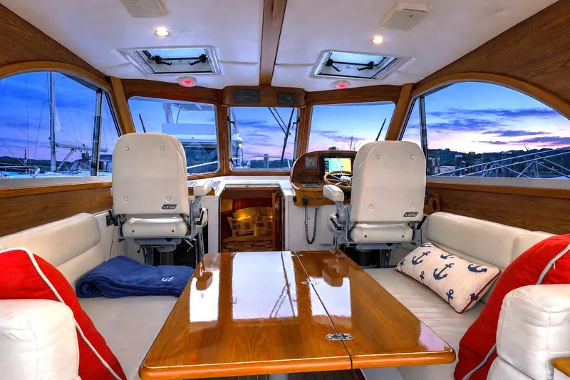 Slide: The Image of Interior of 2007 Legacy 32 Express yacht with elegant seating and nautical decor at sunset. - 11