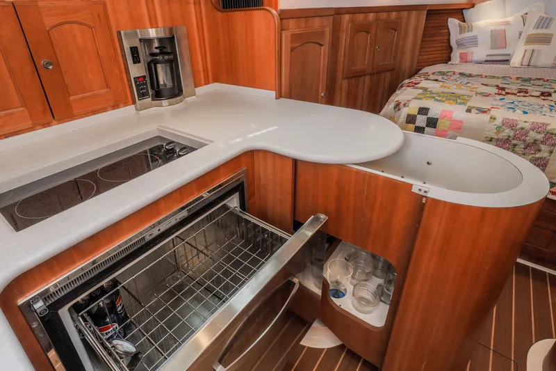 Slide: The Image of Luxurious 2007 Legacy 32 Express yacht interior with modern kitchen and cozy sleeping area. - 6