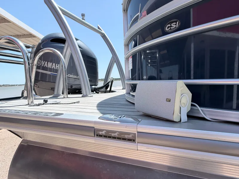 Slide: The Image of A 2018 Trifecta pontoon boat with Yamaha engines and a speaker on the deck. - 8