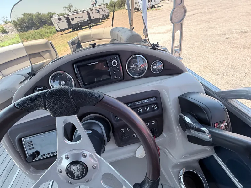 Slide: The Image of The image shows the helm of a 2018 Trifecta boat with a steering wheel and instruments. - 22