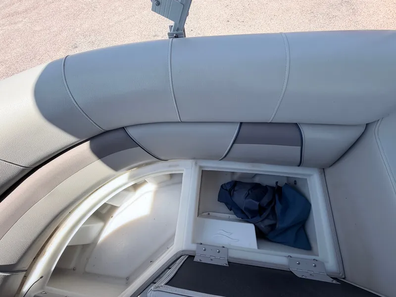 Slide: The Image of A gray cushioned seat on a boat with an open storage compartment underneath. - 16